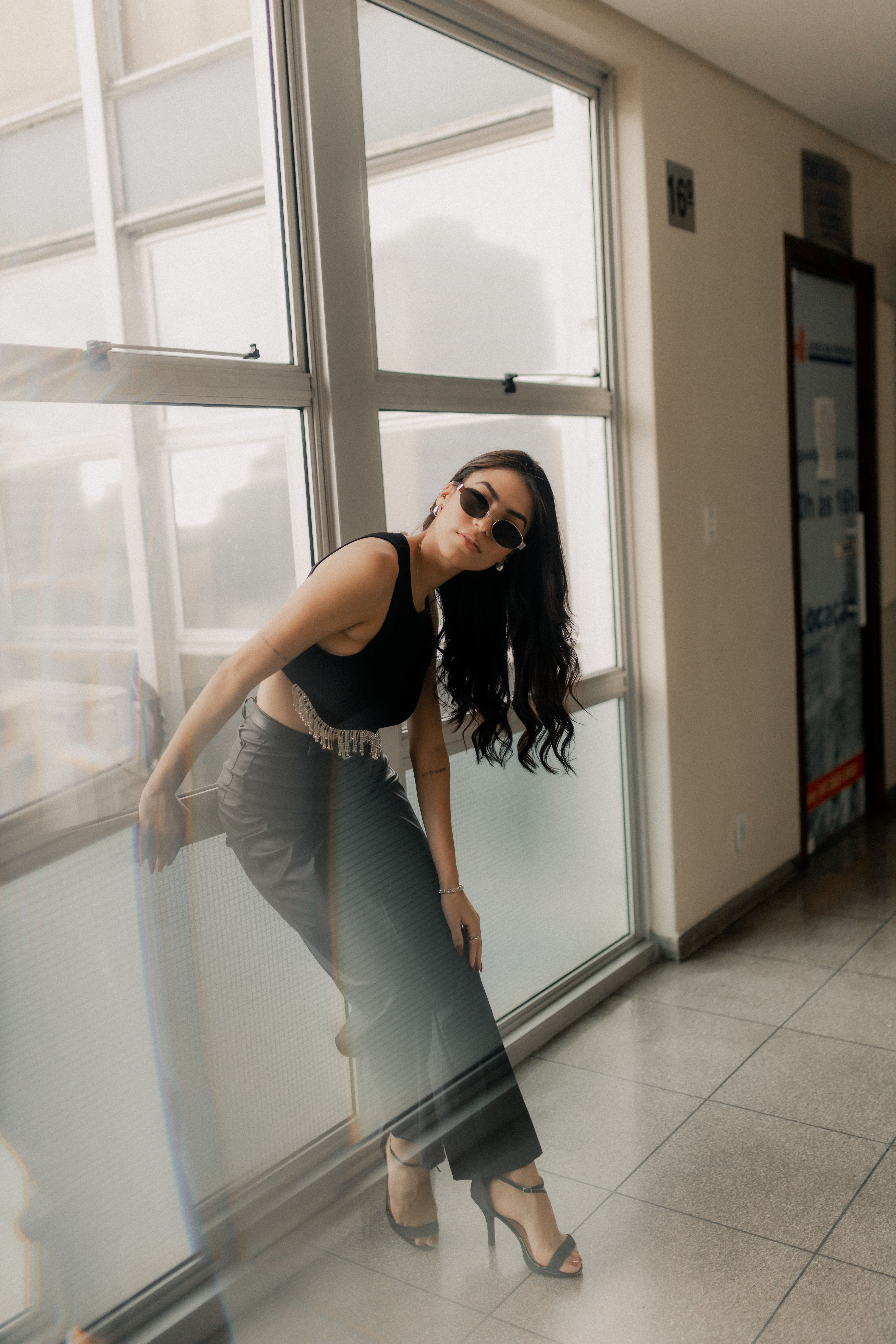 Stylish Woman Posing Indoors in Sunglasses · Free Stock Photo