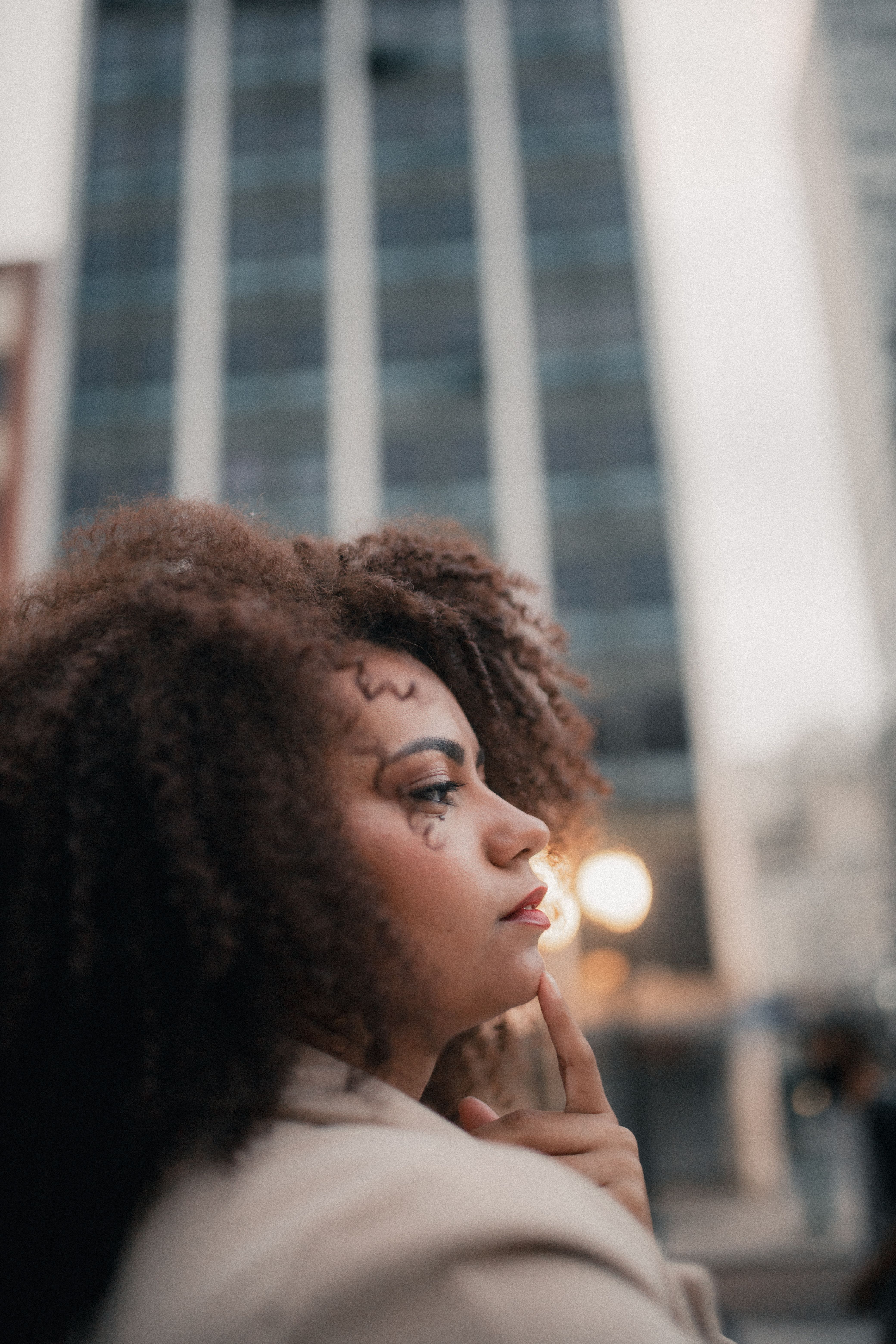 A person sitting thoughtfully with a warm background, reflecting on emotions