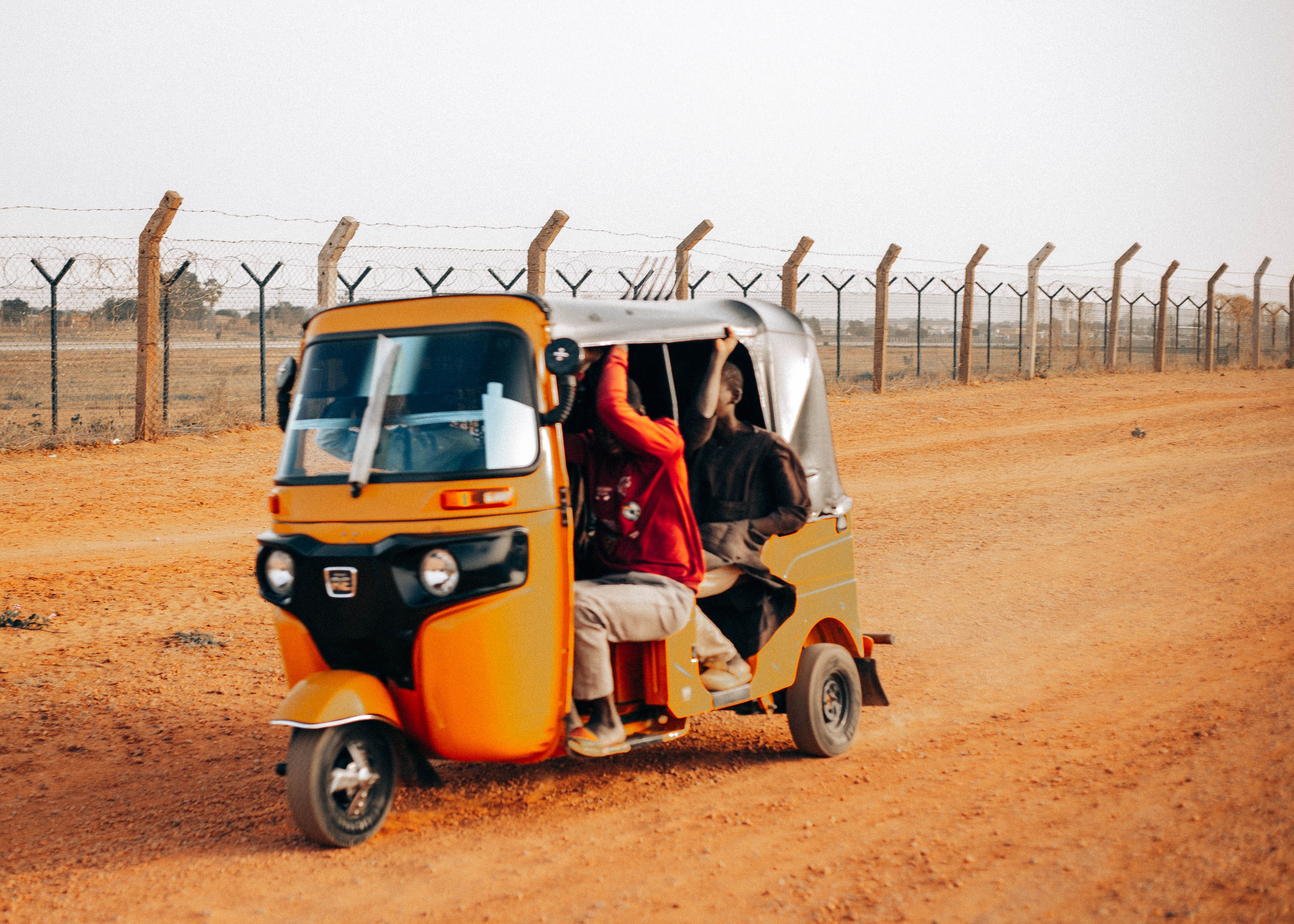 Colorful Tuk-Tuk on Dusty Road in Rural Setting · Free Stock Photo