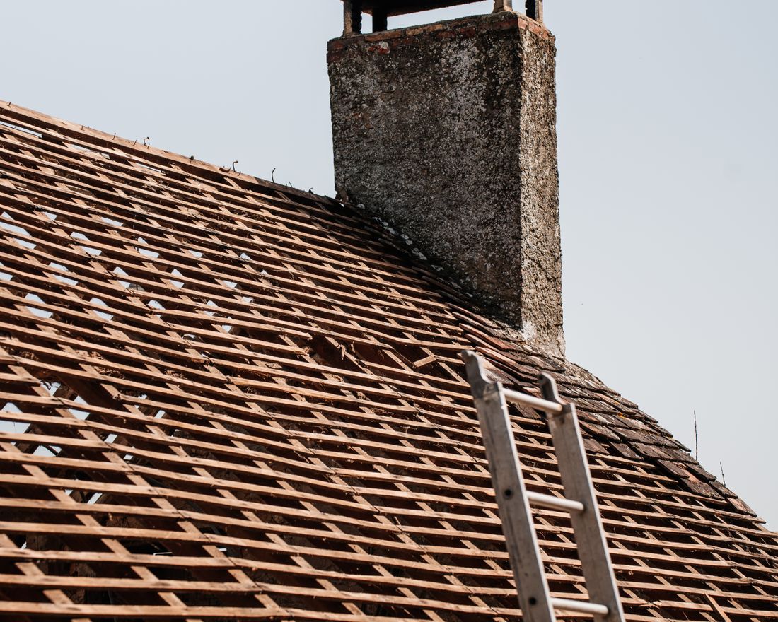 Roofer inspecting a flat roof in Cork