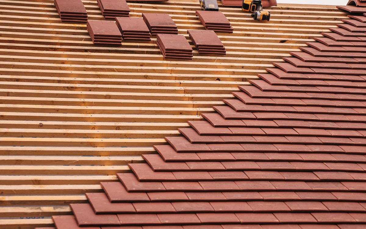 Roofer working safely on a residential roof