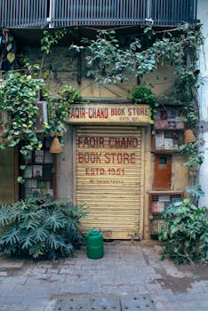 Charming rustic bookstore facade surrounded by lush greenery, old-world charm in an urban setting.