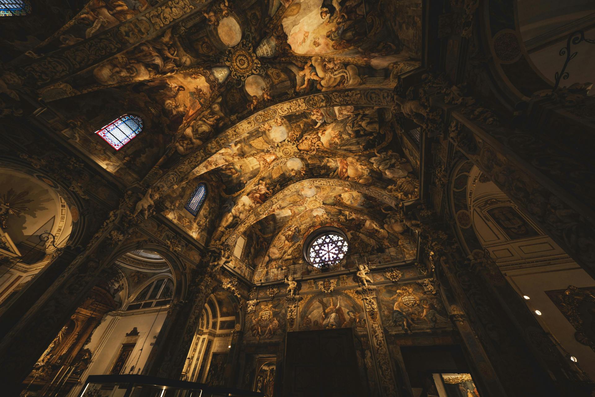 Magnificent baroque church interior featuring ornate frescoes and stained glass.