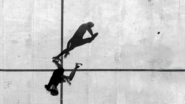 Black and white aerial photo of a person running on concrete in Mar del Plata.