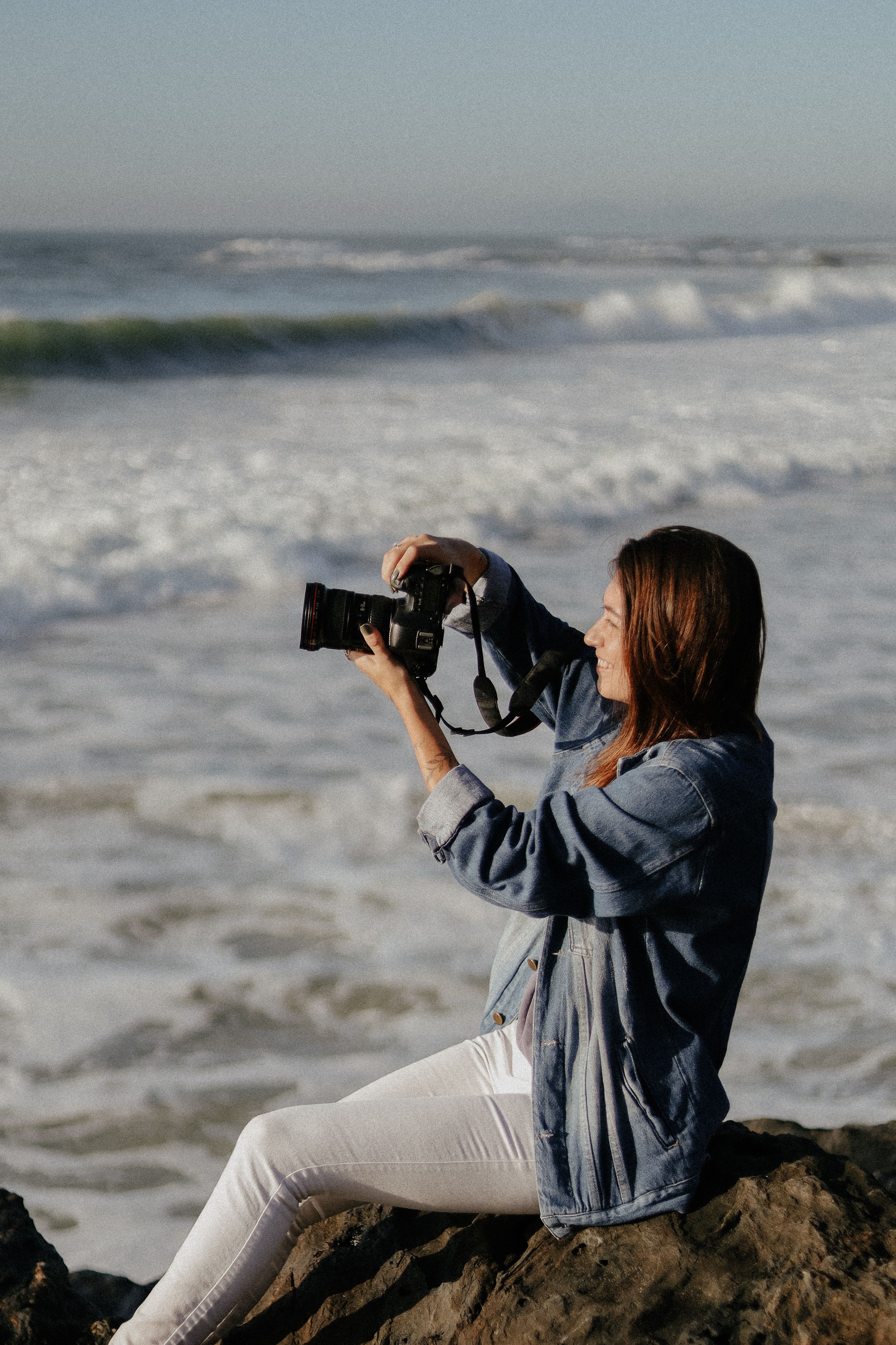 A photographer taking pictures by the seaside in Penha, SC, Brazil. Perfect for travel and lifestyle imagery.