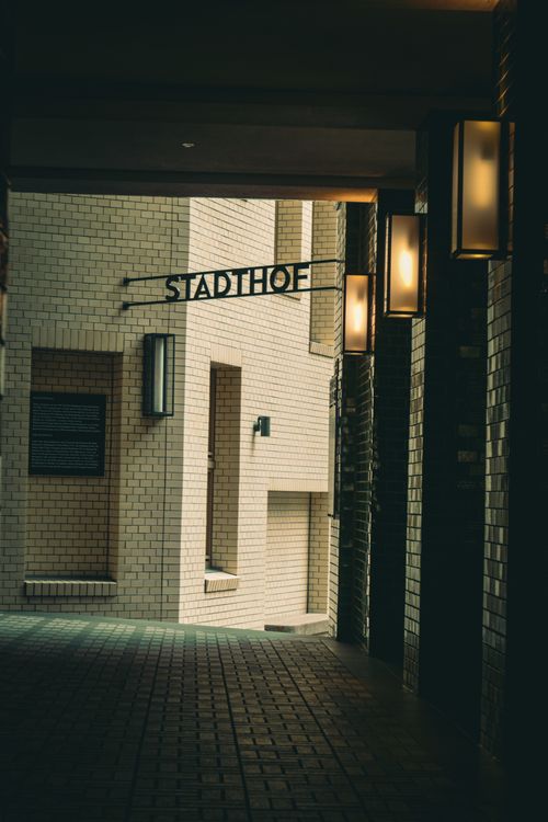 Free A narrow alley in Hamburg with modern lighting and a view of the Stadthof building. Stock Photo