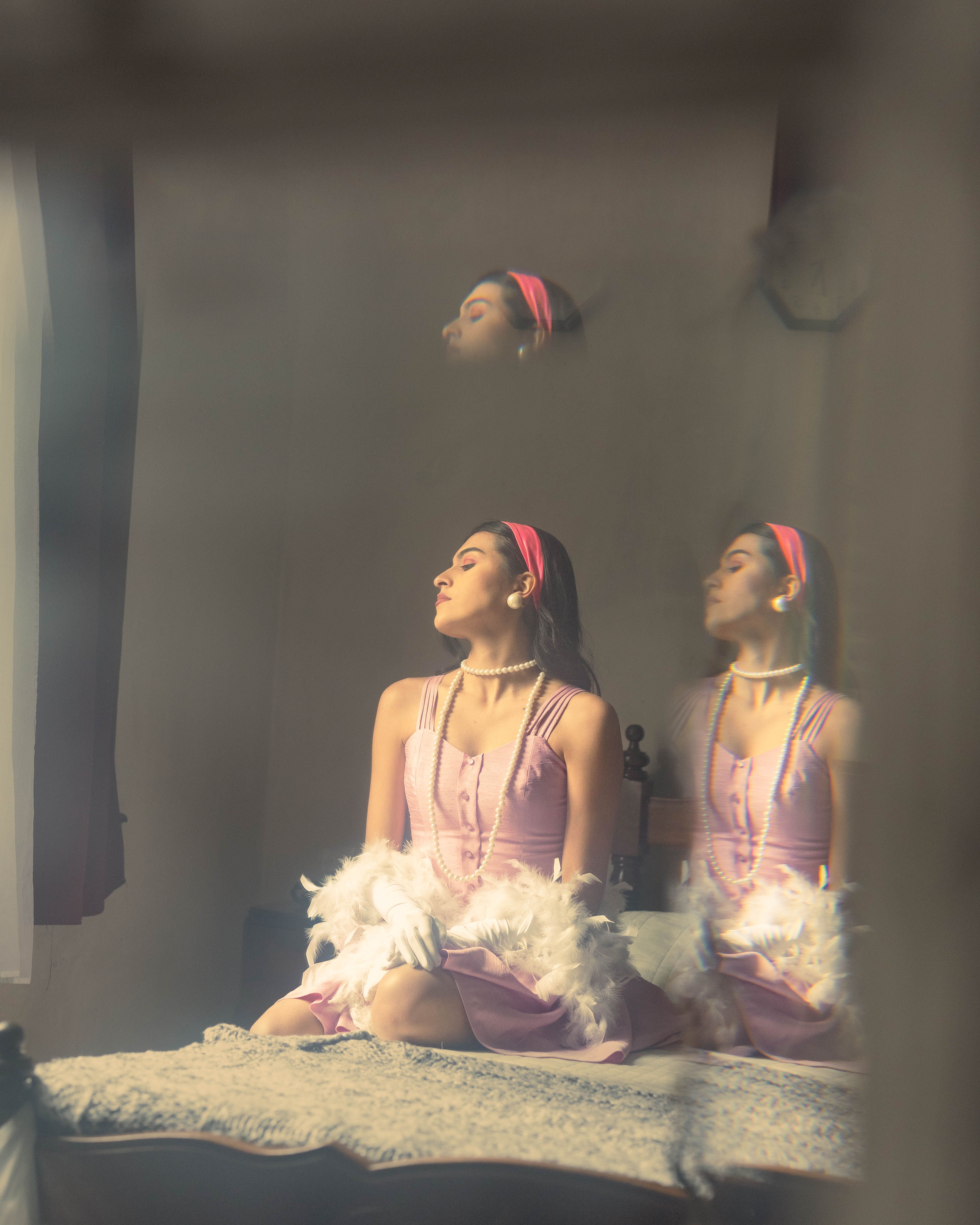 Portrait of a stylish woman in a vintage setting with reflections, capturing elegance and introspection.