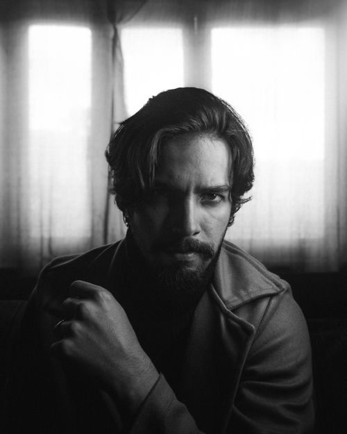 Free Dramatic black and white portrait of a man with a pensive expression indoors. Stock Photo