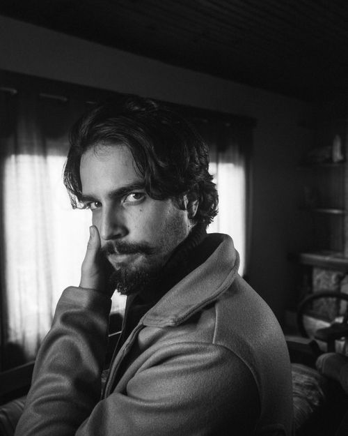 Free Moody black and white portrait of a man indoors with contemplative expression. Stock Photo