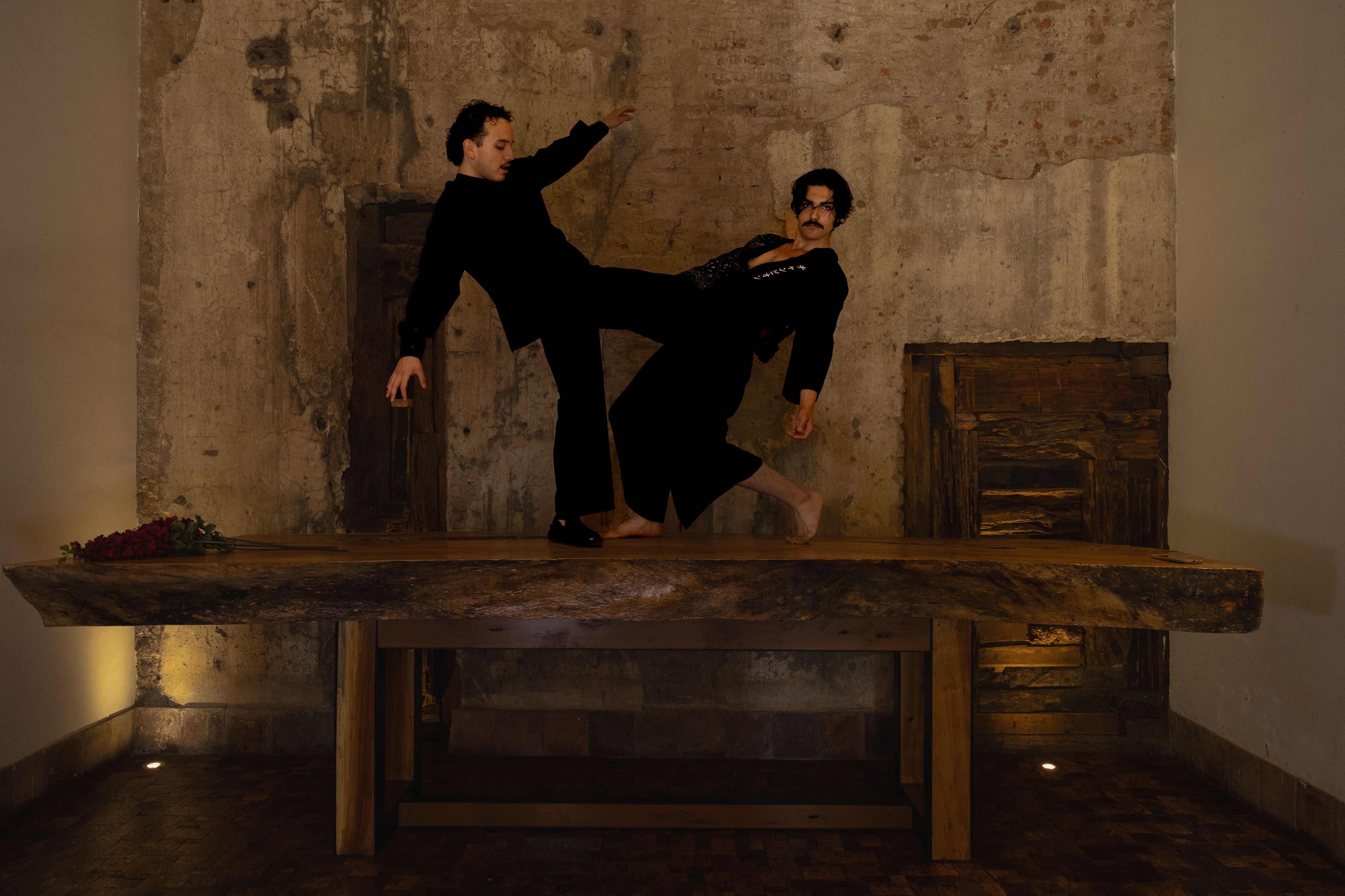Dramatic Indoor Performance on Wooden Table · Free Stock Photo