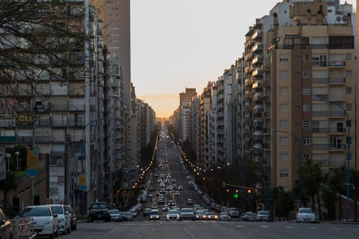 Long avenue lined with tall buildings under a warm sunset in Mar del Plata, Argentina.