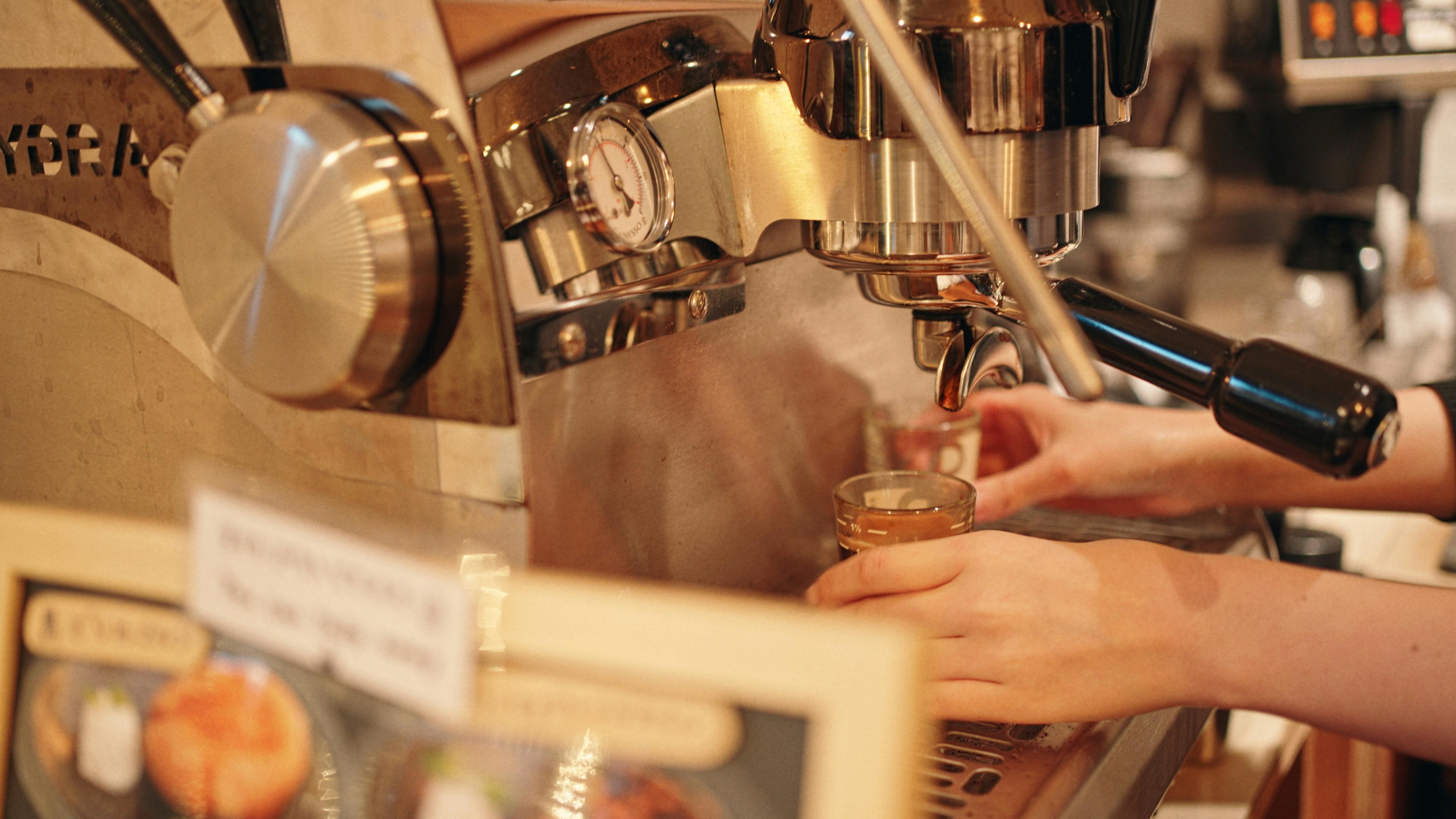 Close-up of barista hands crafting espresso in a Tokyo cafe.