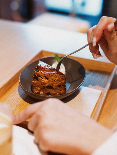 Free Close-up of a person enjoying a slice of homemade cake with coffee in Tokyo, Japan. Stock Photo