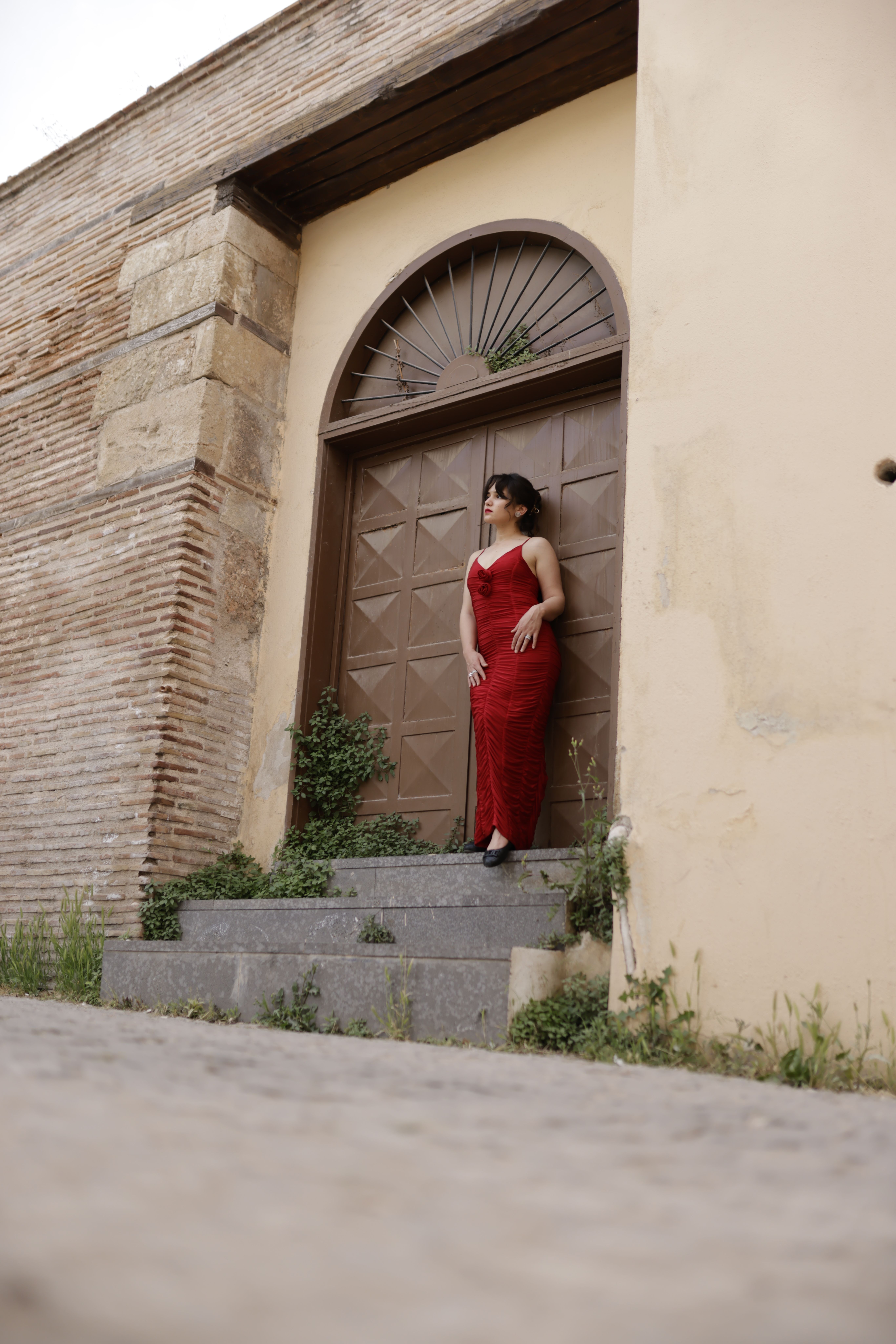Elegant Woman in Red Dress by Rustic Doorway · Free Stock Photo