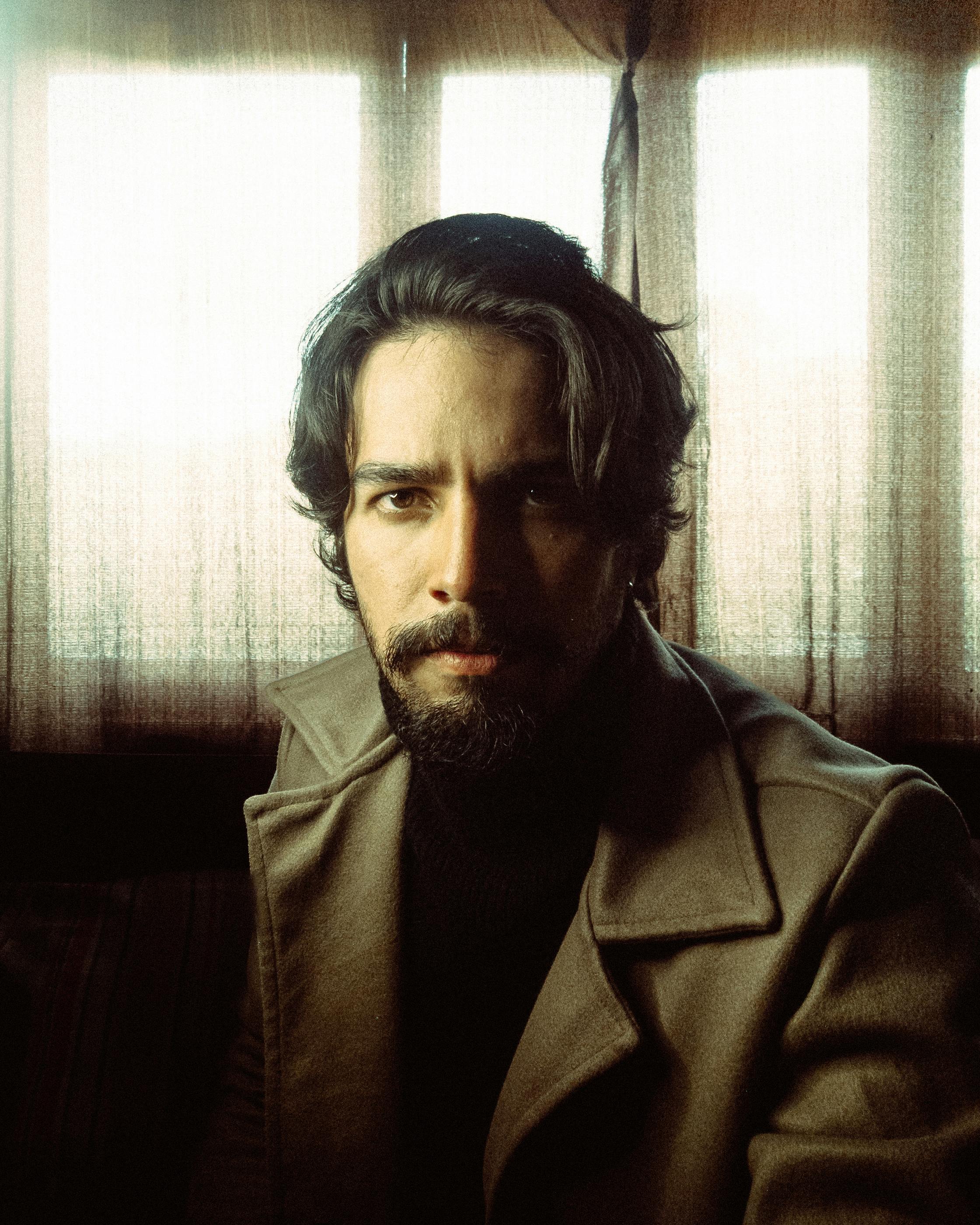 Man in soft natural light — warm diffused Nordic portrait with contemplative honest expression