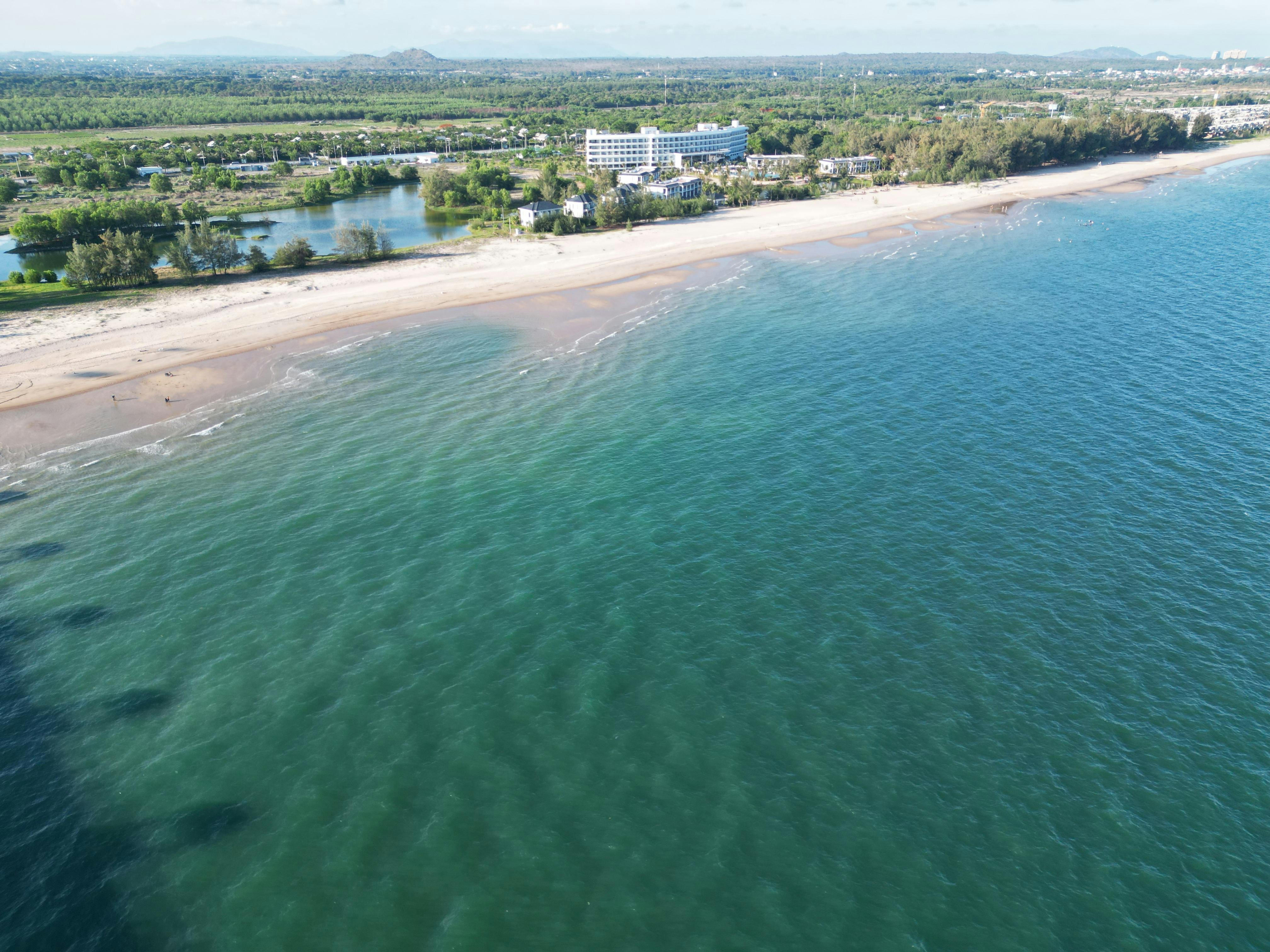 Stunning aerial view of Hồ Tràm Beach with clear blue water and sandy shores.