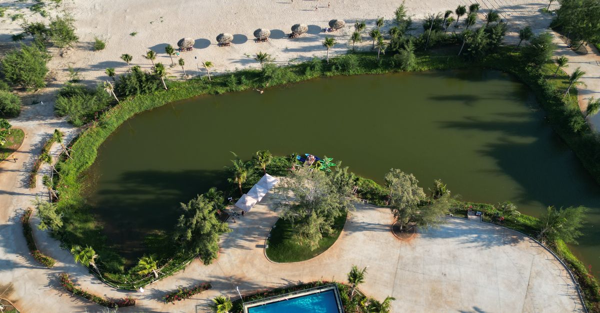 Stunning aerial shot of Hồ Tràm beach, lagoon, and resort pool in Vietnam.