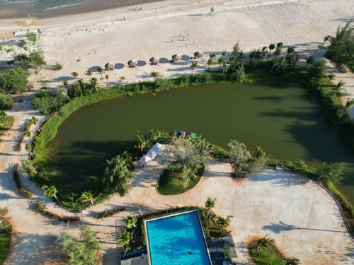 Free Stunning aerial shot of Hồ Tràm beach, lagoon, and resort pool in Vietnam. Stock Photo