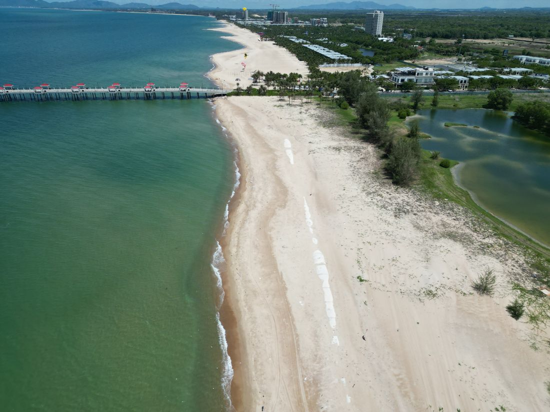 The wide beachfront at Ho Tram with the pier and coastal landscape