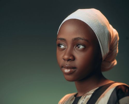 Free Captivating portrait of a young woman gazing thoughtfully in a studio setting. Stock Photo