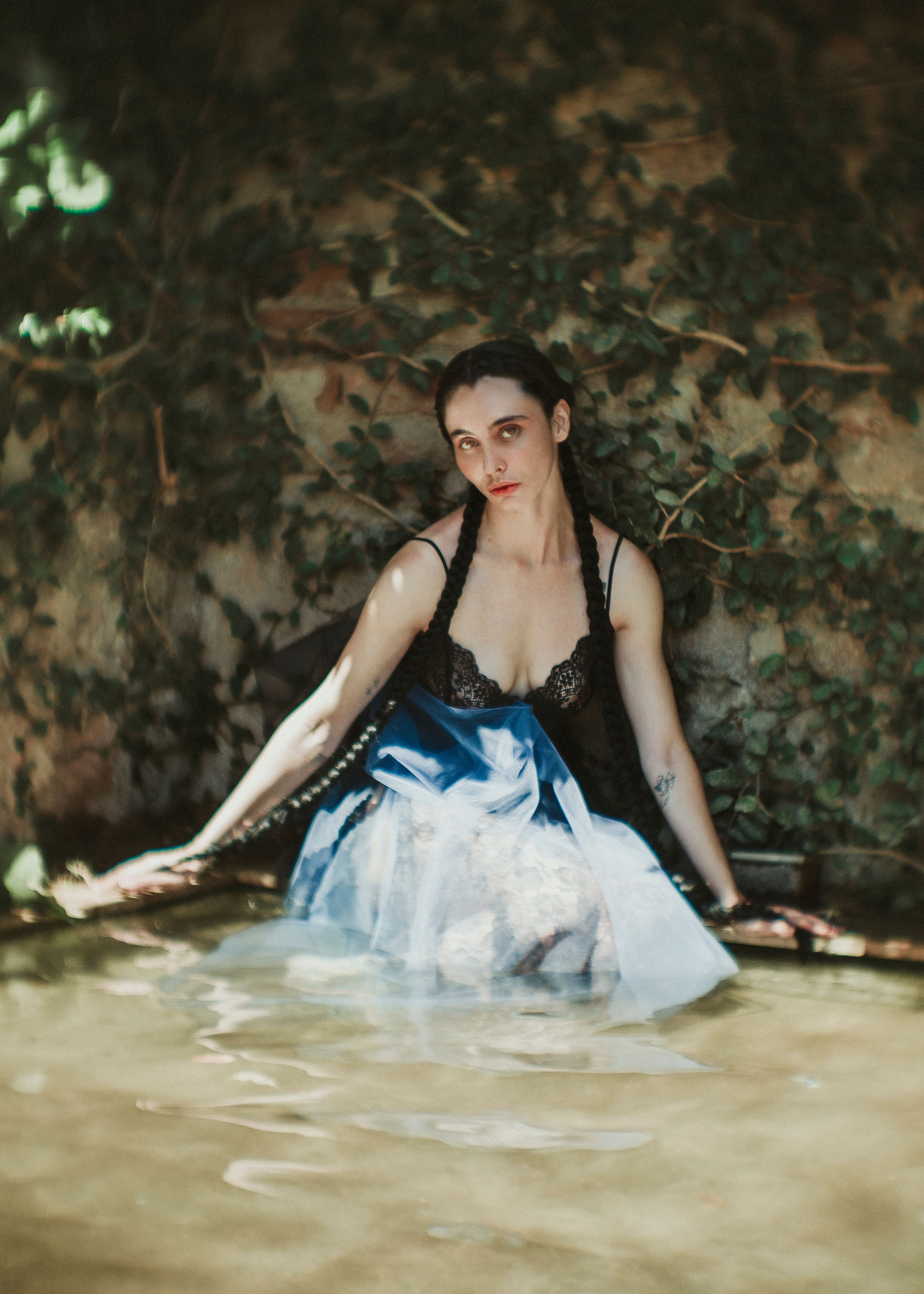 Artistic Portrait of Woman in Water with Ivy Backdrop · Free Stock Photo