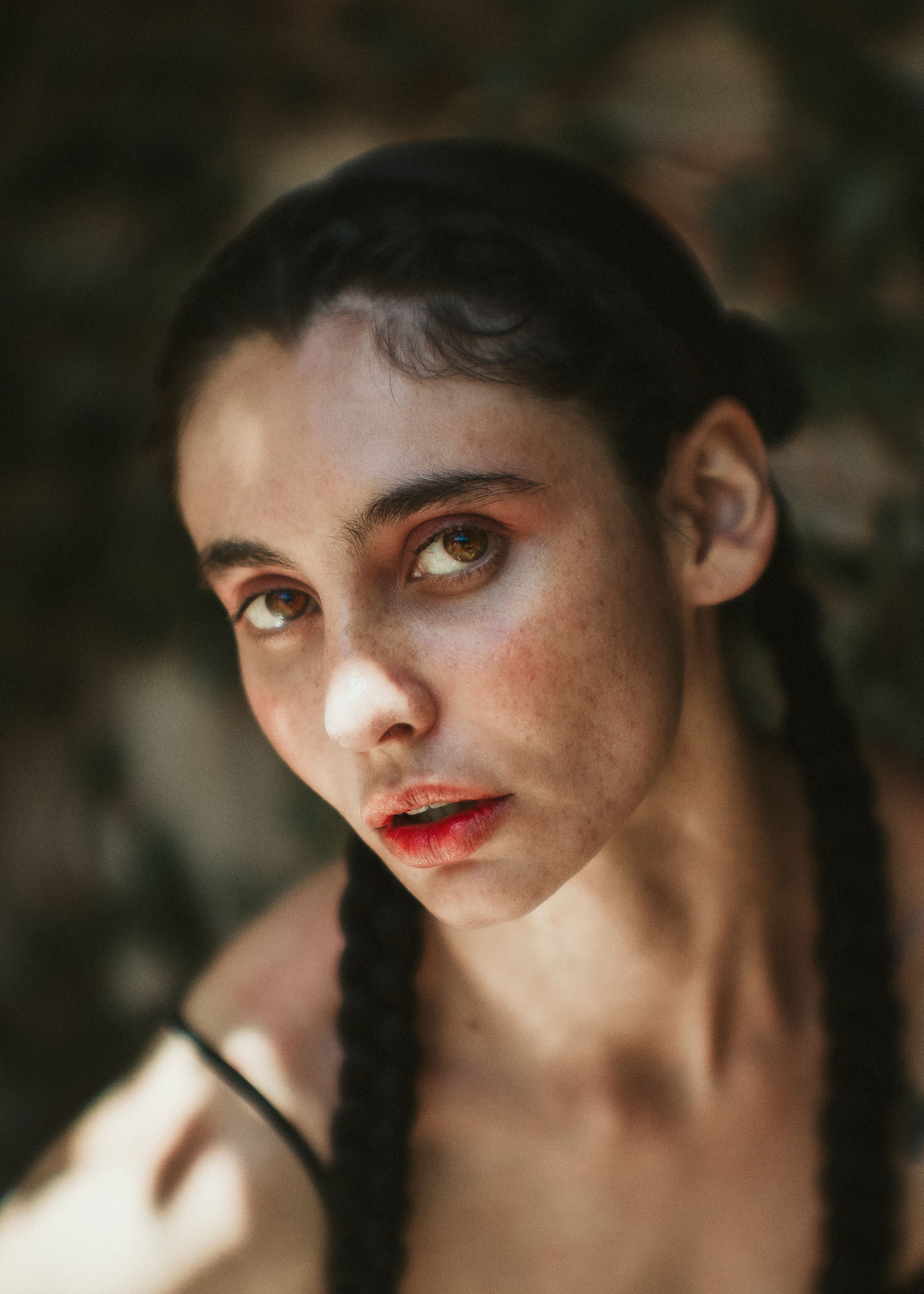 Portrait of a Woman with Braided Hair in Sunlight · Free Stock Photo