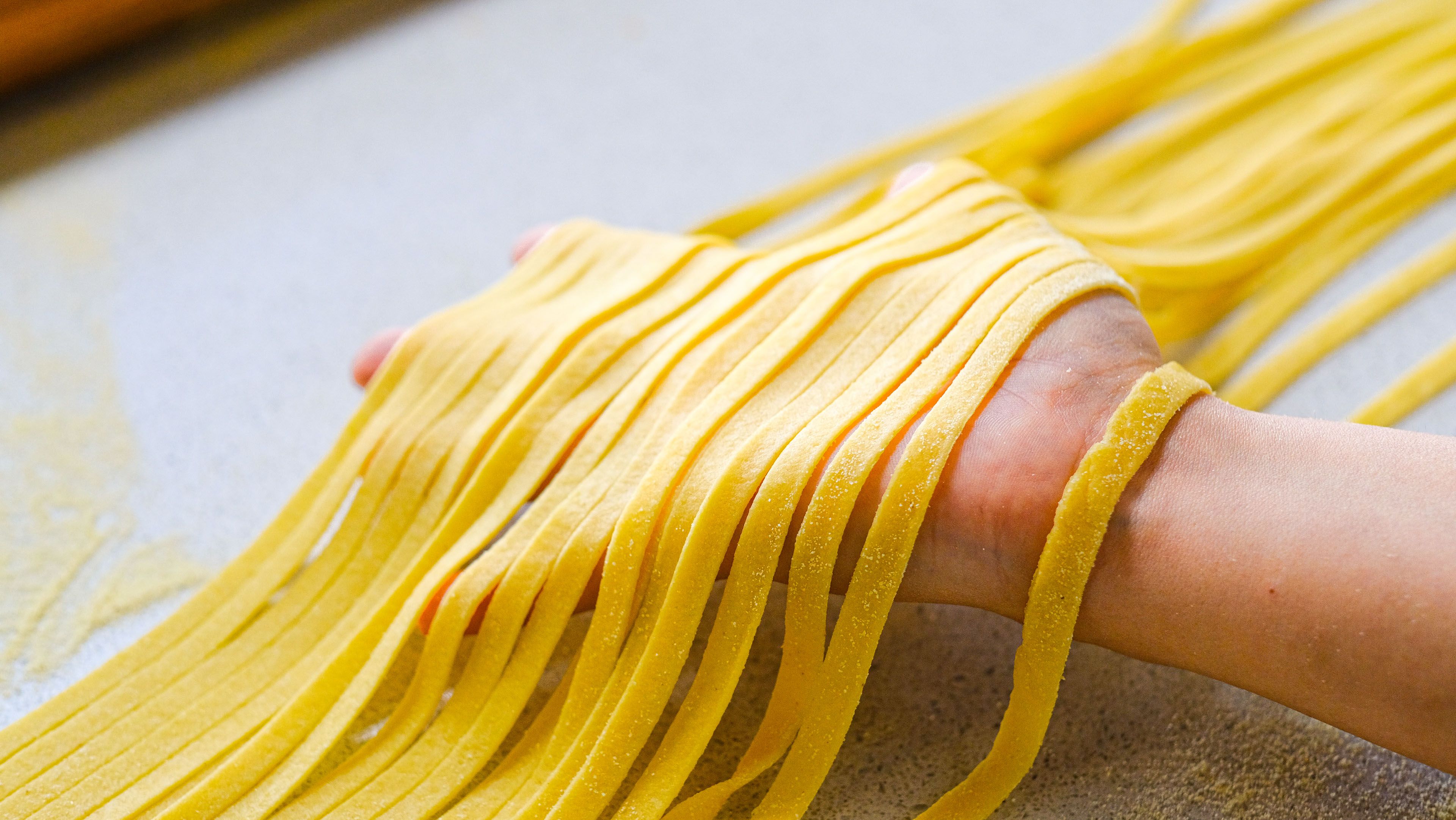 Close-up of Fresh Pasta Being Handled · Free Stock Photo