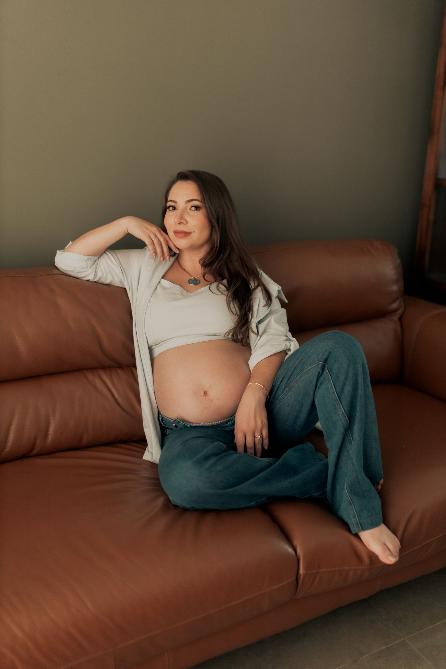 Femme enceinte prenant un moment de repos sur un canapé lumineux