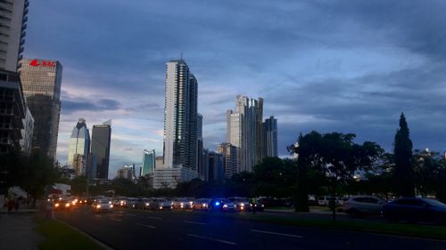 Free Panama City skyline with modern skyscrapers and traffic during twilight. Stock Photo