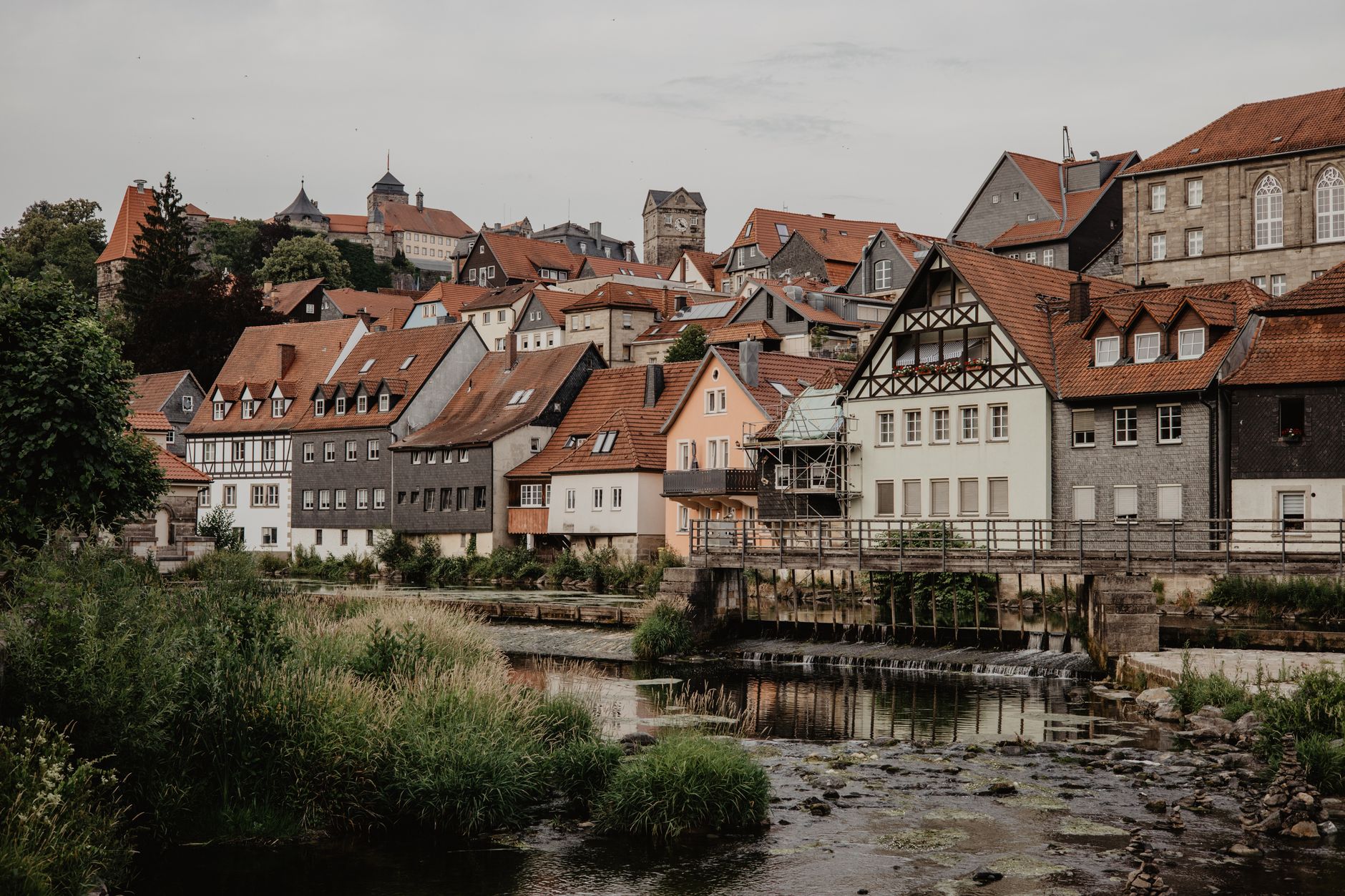 Traditional half-timbered houses beside a calm German river