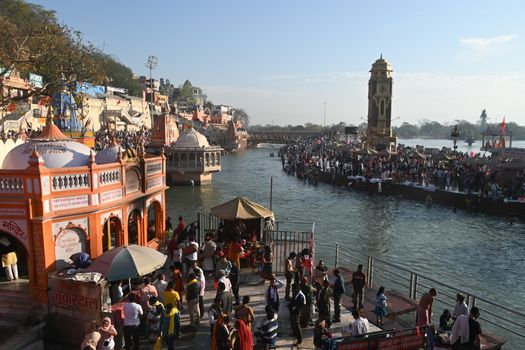 A vibrant scene at the Ganges Ghats in Haridwar during a Hindu festival, showcasing cultural richness.