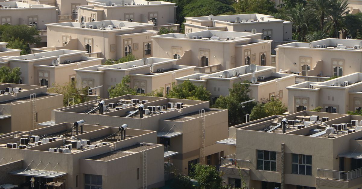 Aerial photo of Dubai's residential area showcasing uniform, modern architecture amid greenery.