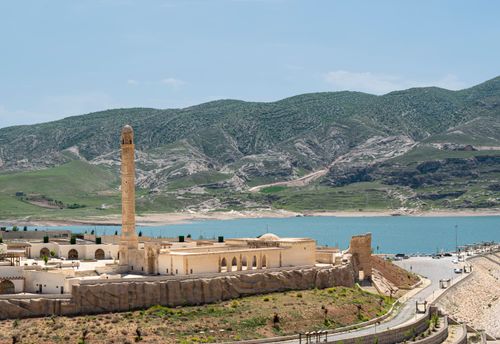 Free Stunning view of Hasankeyf's ancient mosque, river, and mountains under a clear sky. Stock Photo