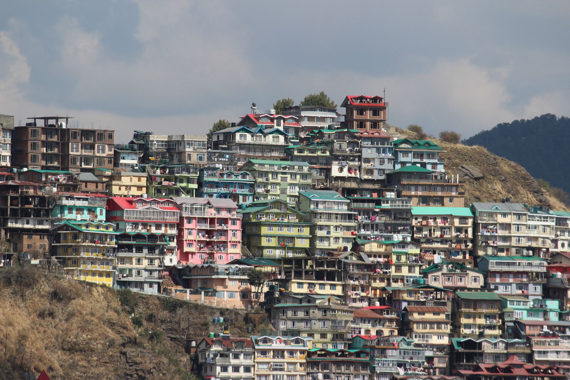 Shimla's colourful homes stacked down the hillside - a reminder that "five minutes away" often means a steep climb