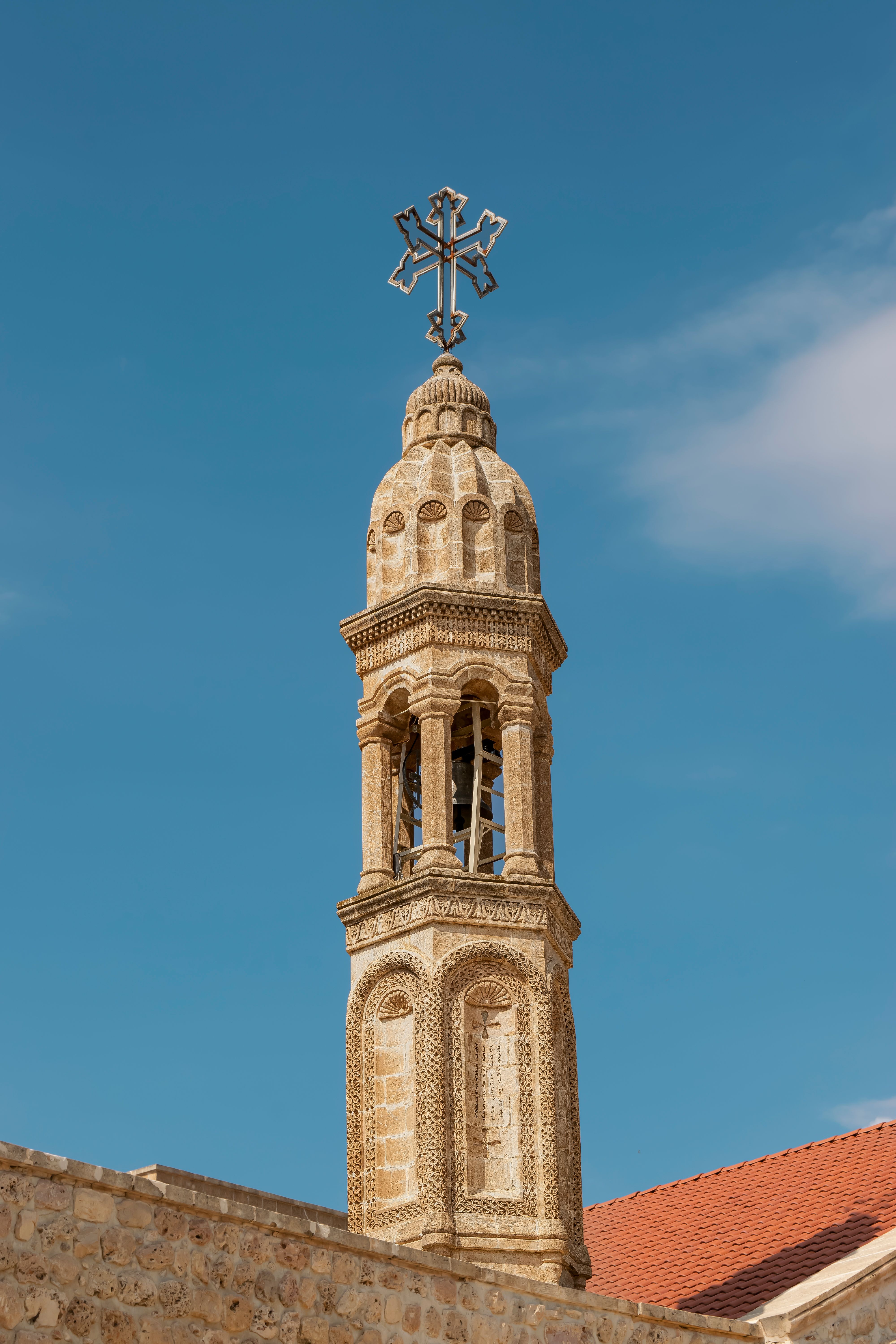 Historic Church Tower with Cross Against Blue Sky · Free Stock Photo