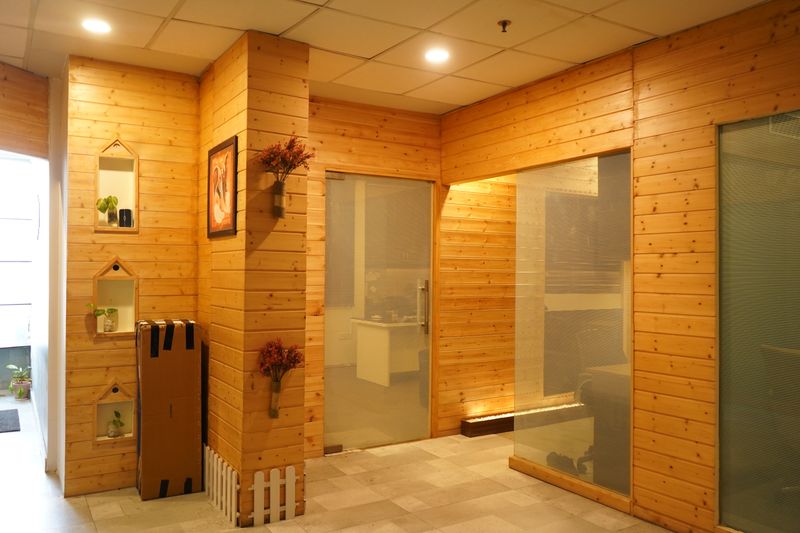 warm white office wall with light wood shelving