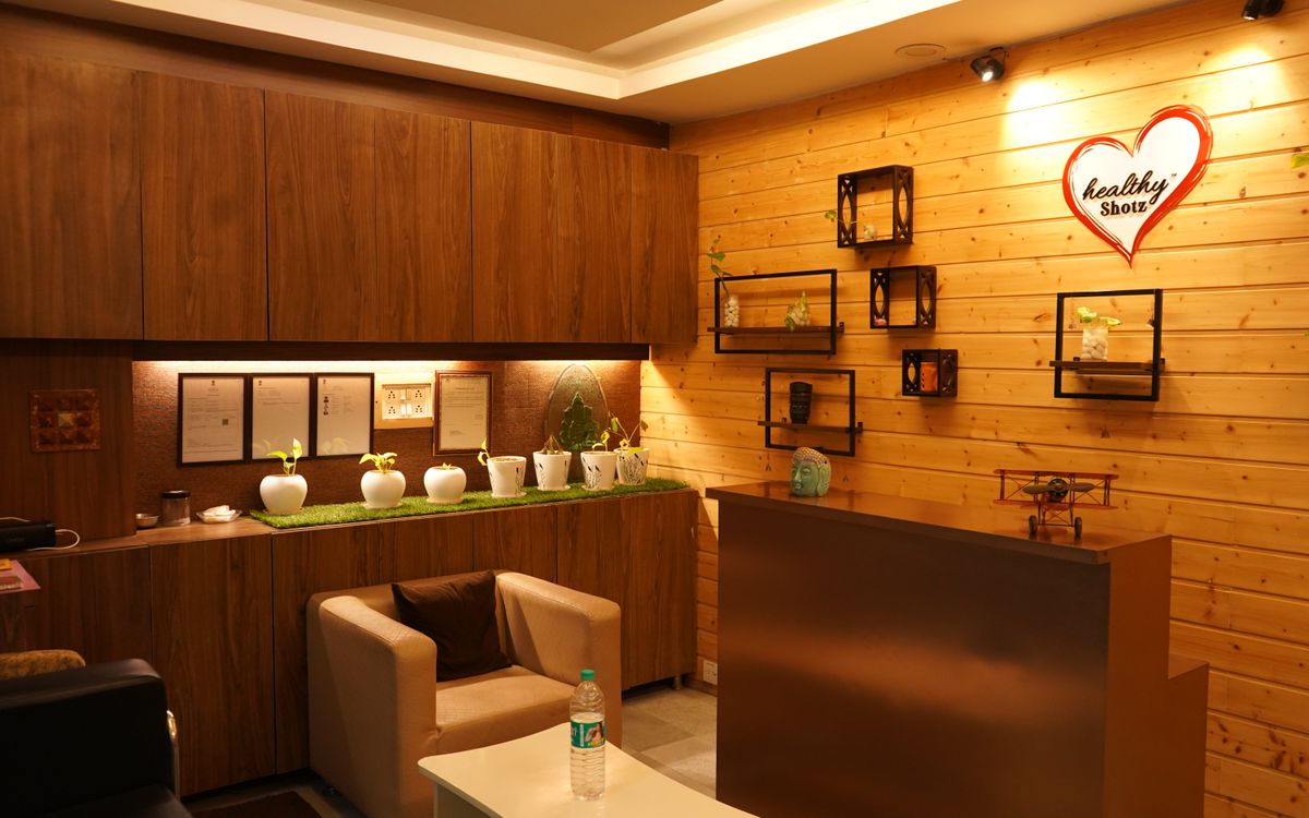 Warm and cozy reception area with wooden decor, indoor plants and soft lighting