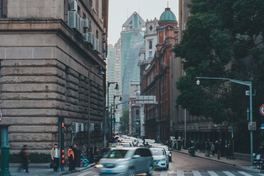 A busy street in a city center with high-rise buildings and traffic, capturing urban life.