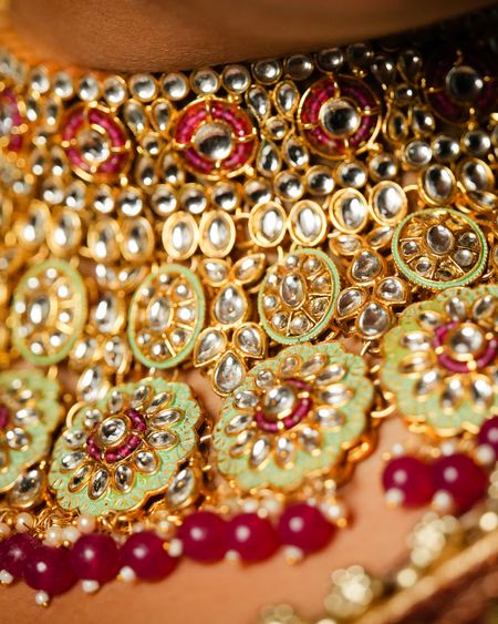 Close-up of a pastel mint kundan choker with ruby-red drops