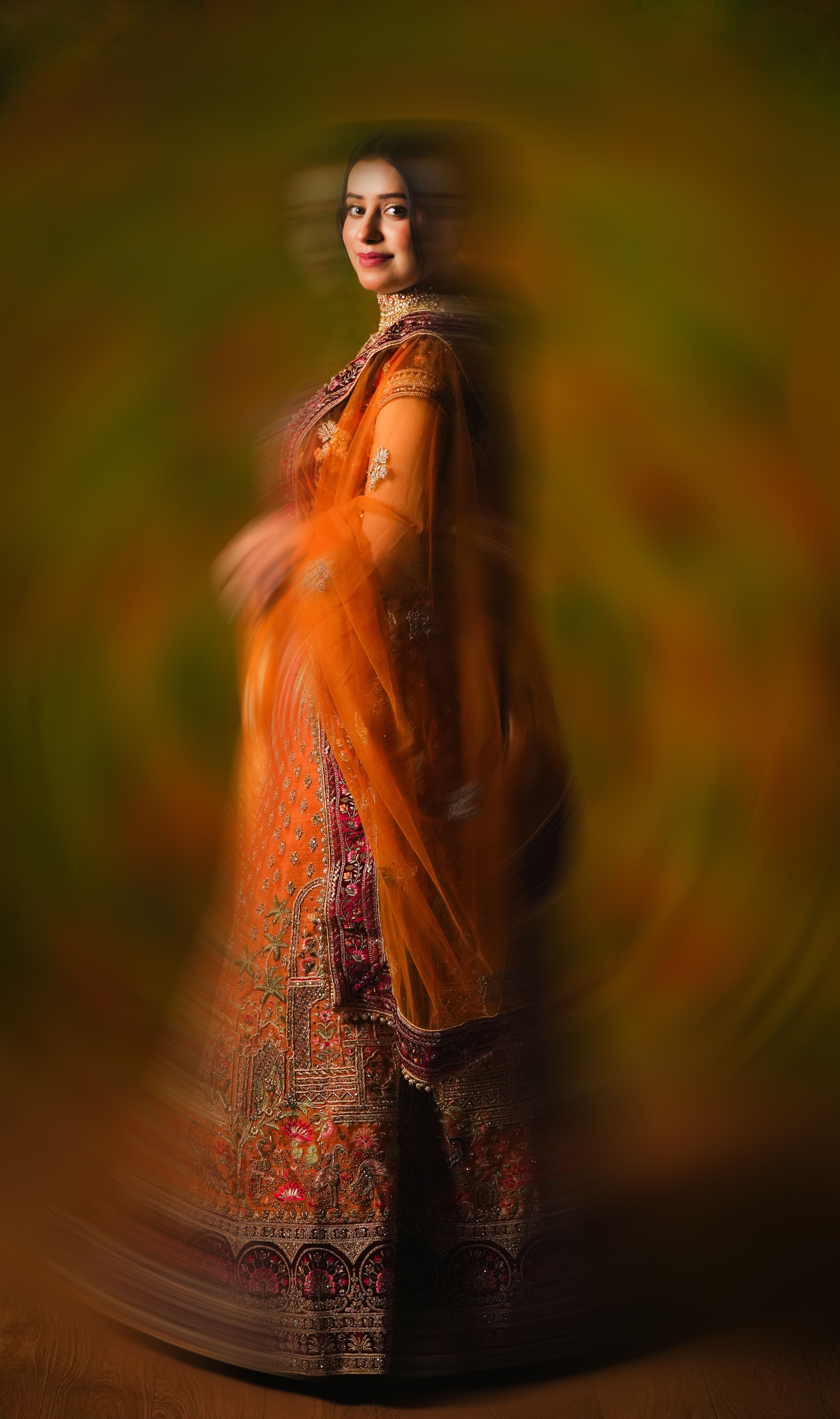 Portrait of a woman in vibrant traditional attire with artistic motion blur effect.