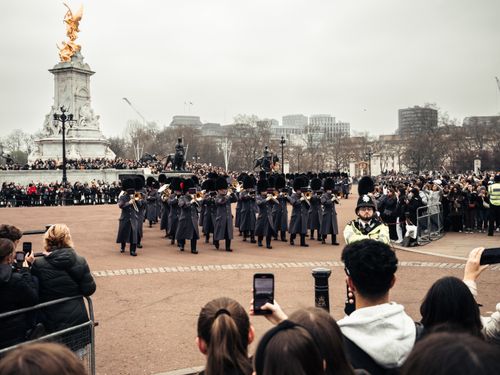 Free Majestic changing of the guard ceremony at Buckingham Palace, London with marching soldiers in uniform. Stock Photo