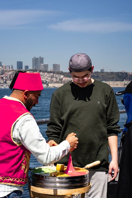 Free Street vendor in Istanbul serving traditional Turkish ice cream on a sunny day by the Bosphorus. Stock Photo