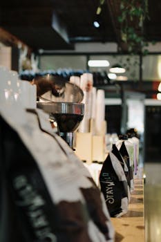 Cozy coffee shop interior showcasing brewing equipment and packaged coffee bags.