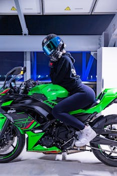 Motorcyclist poses on a vibrant green sports bike in an urban setting.