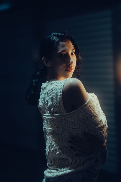 Free Elegant portrait of a woman with moody lighting creating an artistic effect. Stock Photo