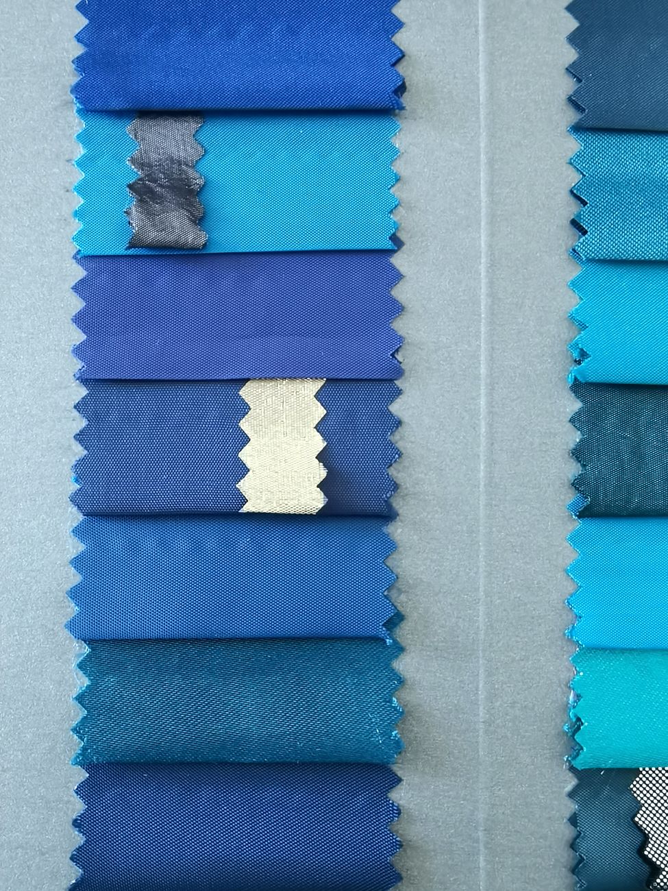 Blue fabric swatches laid out to compare texture and finish