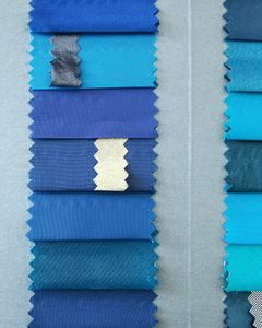 Collection of blue fabric swatches in different shades and textures for design inspiration.