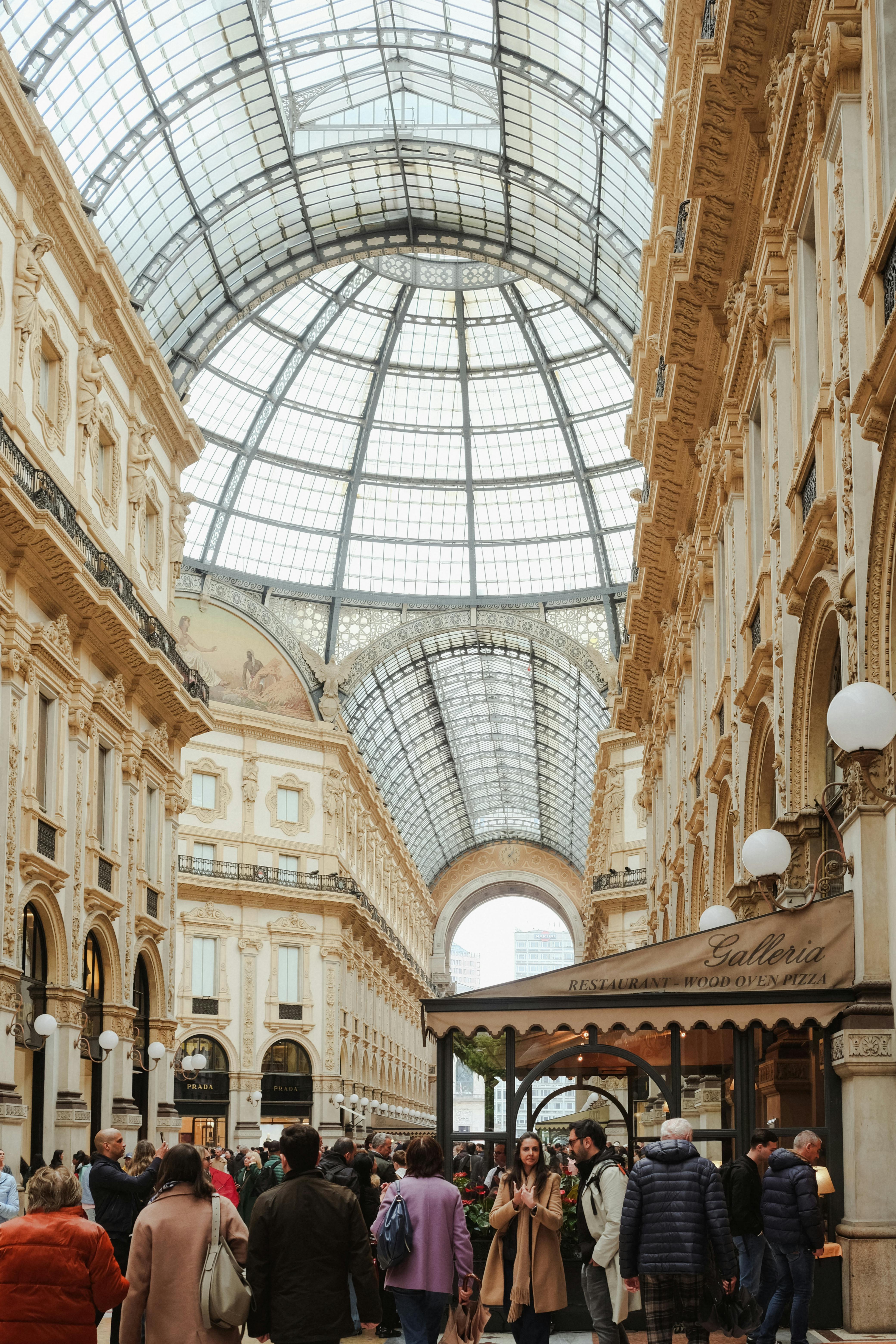 Crowds explore the historic Galleria Vittorio Emanuele II in Milan, Italy.
