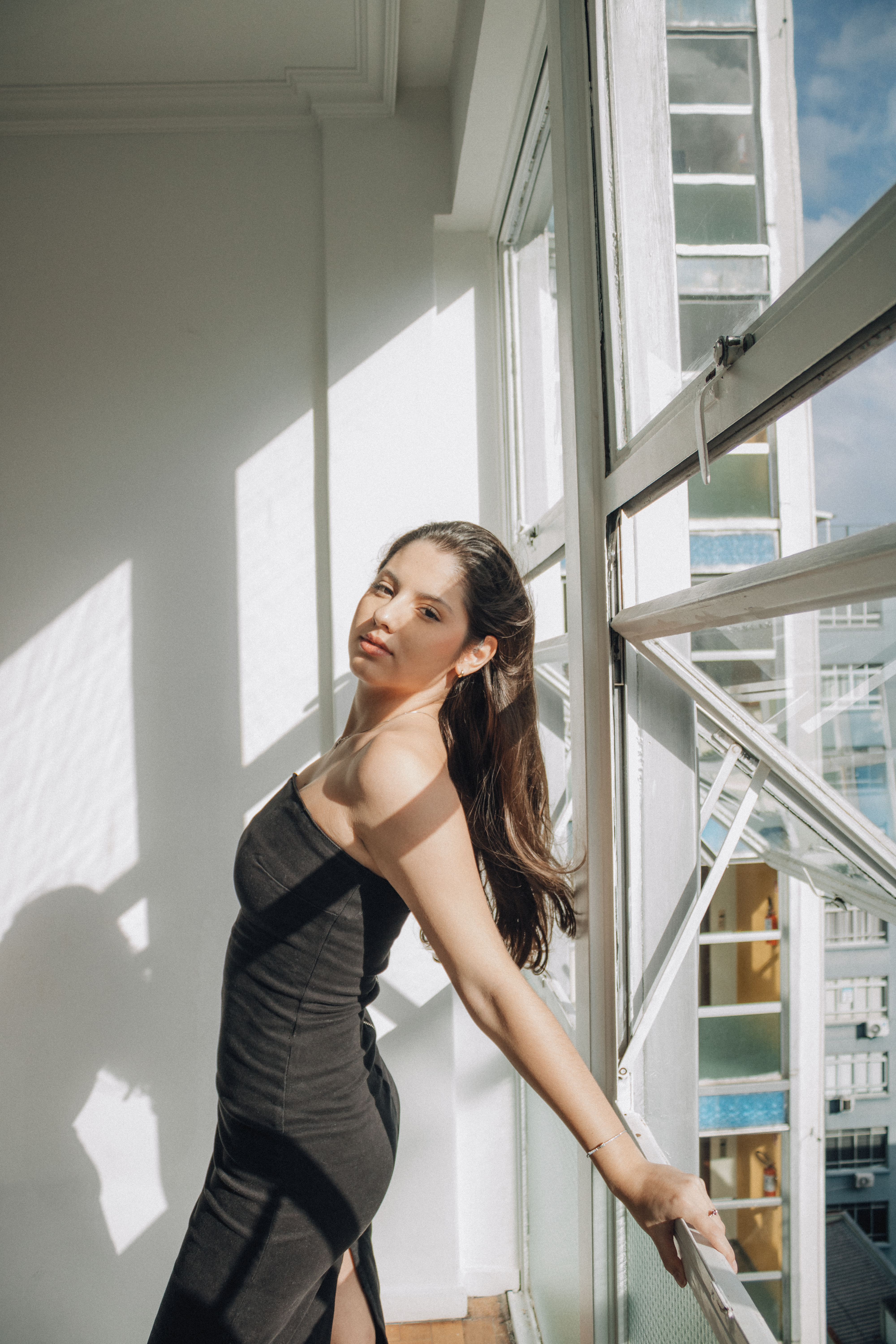 Elegant Woman Posing in Sunlit Interior Window · Free Stock Photo