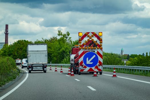 Photo by Magda Ehlers City highway under maintenance with traffic cones and warning signs directing vehicles.